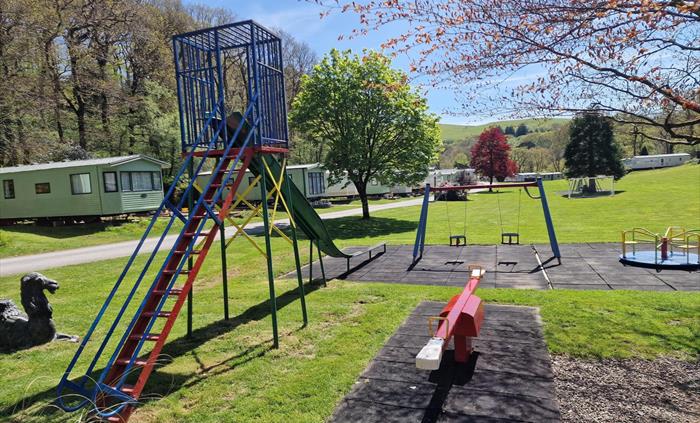 Play area with slide, swings, see saw and roundabout
